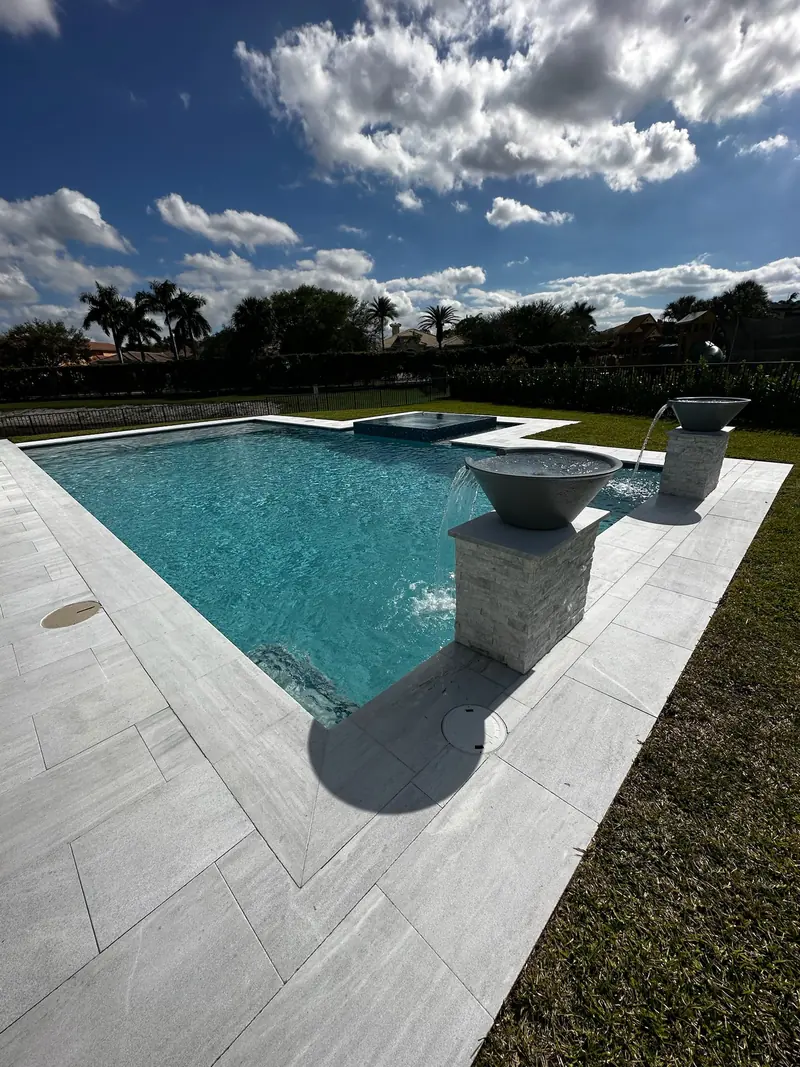 Fire bowl on a stone pillar at the corner of a pool