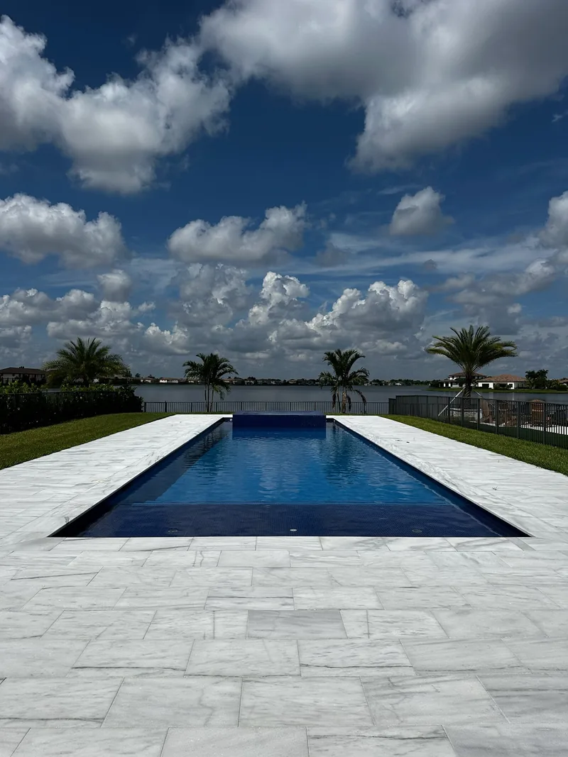 Long pool pointing toward a lake under a big sky