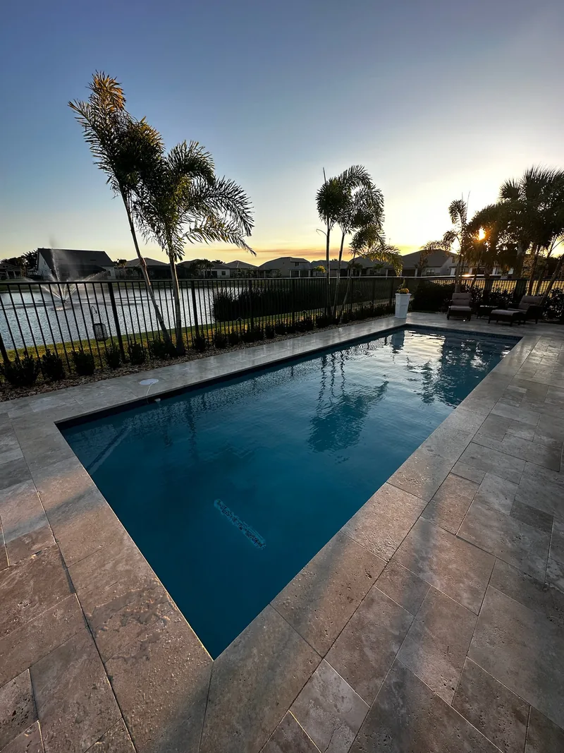 Pool in the evening with palm reflections on dark water