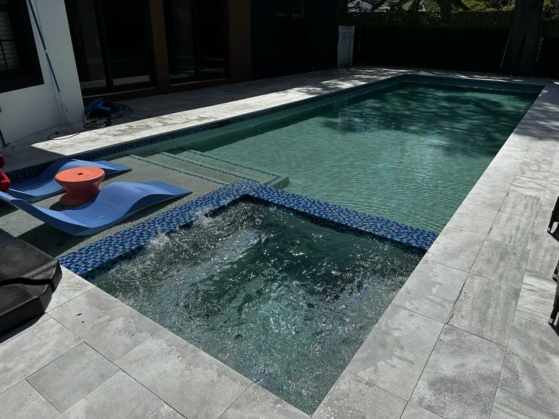 Bubbling spa beside a pool sun ledge