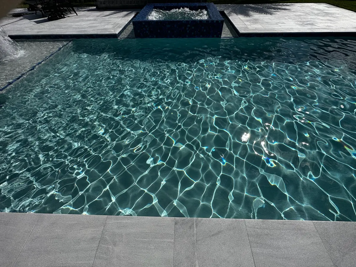 Clear turquoise water with sunlight patterns over the pool floor