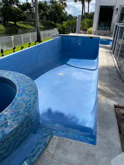 Pool with a glass mosaic tiled spa and a smooth blue interior finish