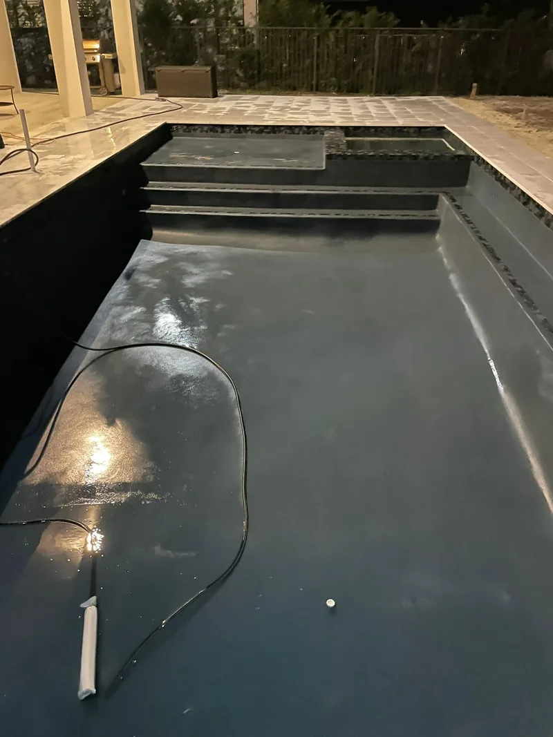 Narrow pool with a dark interior finish and steps at one end