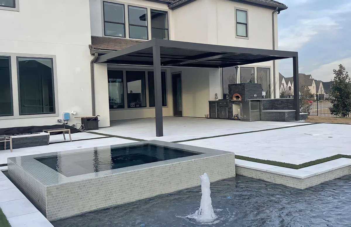Modern home with a pergola, a raised spa and a bubbler in the pool